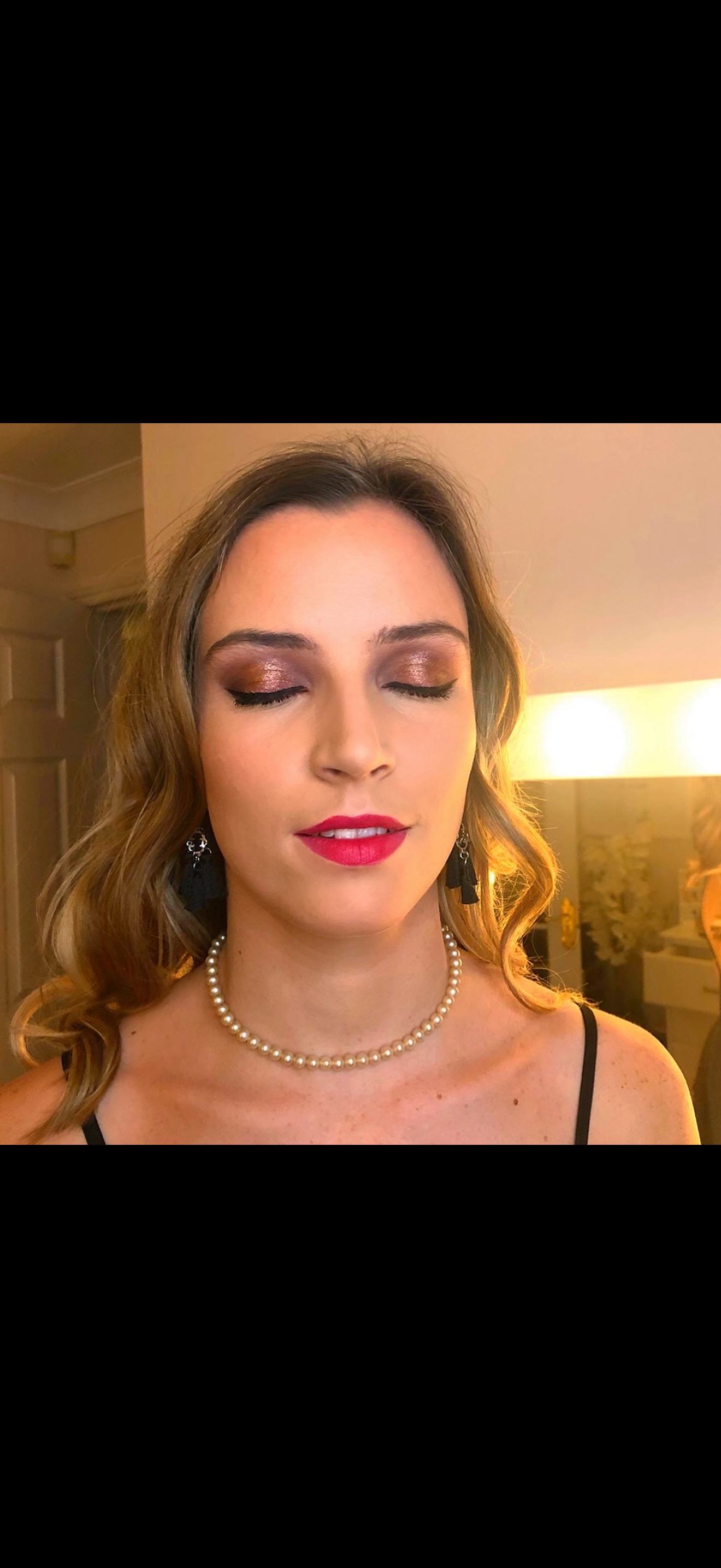 Client with a bright pink lip and shimmering smoky eyes