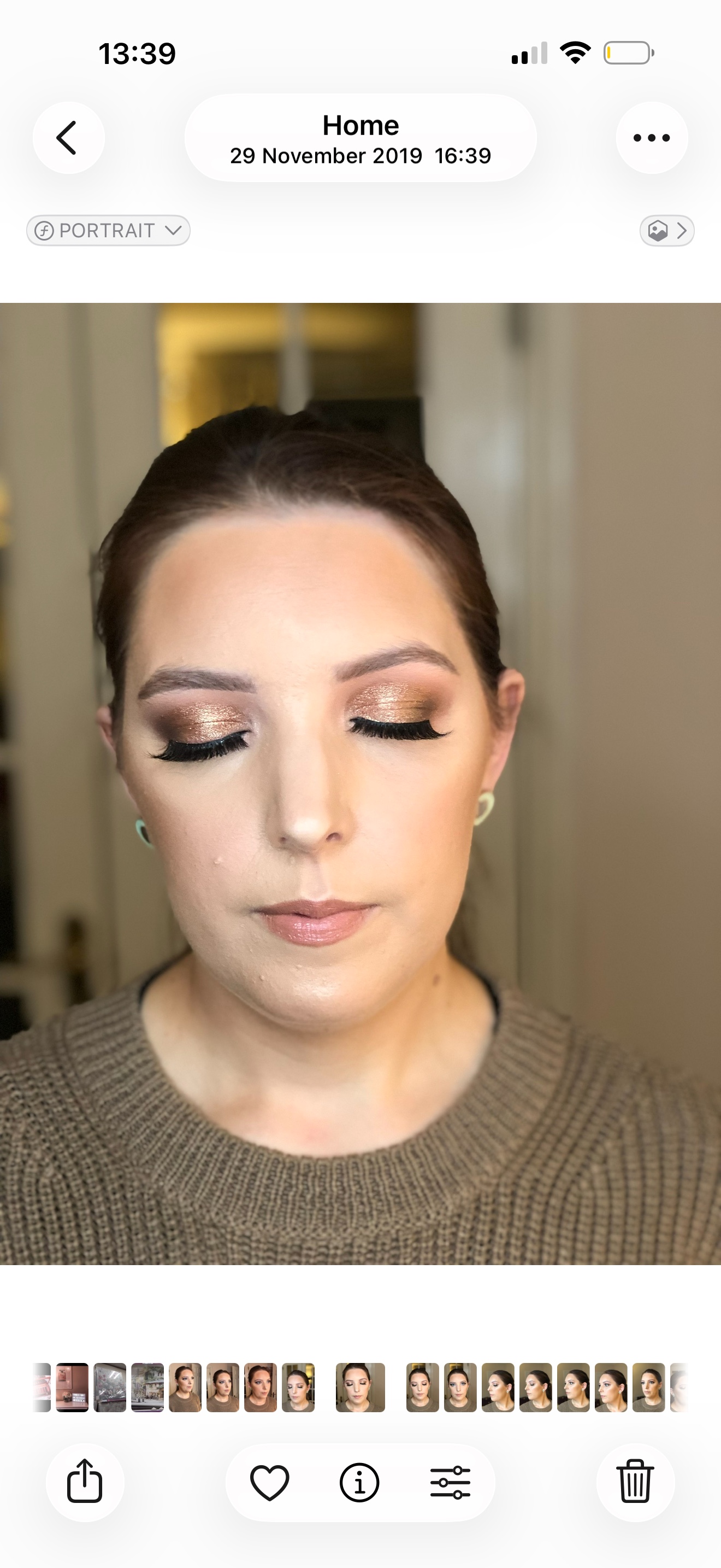 Client looking down to show warm shimmer eyeshadow and a subtle lip